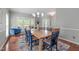 Elegant dining room with a large wooden table, seating for six, a stylish rug, and ample light at 1401 Everette Fields Rd, Morrisville, NC 27560