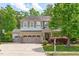 Attractive two-story home with a well-manicured lawn, three-car garage, and inviting front porch at 1401 Everette Fields Rd, Morrisville, NC 27560