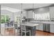 Bright eat-in kitchen features a large island with seating, stainless steel appliances, and granite countertops at 1401 Everette Fields Rd, Morrisville, NC 27560