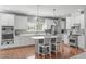 Bright kitchen featuring white cabinets, a center island with seating, and stainless steel appliances at 1401 Everette Fields Rd, Morrisville, NC 27560