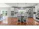 Open kitchen with stainless steel appliances, island with seating, and hardwood floors at 1401 Everette Fields Rd, Morrisville, NC 27560
