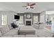 Spacious living room with a fireplace, plush seating, and neutral decor, ideal for relaxation at 1401 Everette Fields Rd, Morrisville, NC 27560