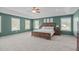 Large main bedroom with tray ceilings, ample natural light, and a calming color palette at 1401 Everette Fields Rd, Morrisville, NC 27560