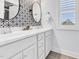 Stylish bathroom with double sinks, elegant mirrors, and modern fixtures at 1448 Big Falls Dr, Wendell, NC 27591