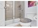 Modern bathroom featuring a glass-enclosed shower with neutral tile and an adjacent toilet at 1448 Big Falls Dr, Wendell, NC 27591