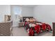 Charming bedroom with a floral-themed bedspread, decorative pillows, and natural light from the window at 1448 Big Falls Dr, Wendell, NC 27591