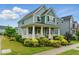 Charming two-story home with a welcoming front porch and beautifully landscaped front yard at 1448 Big Falls Dr, Wendell, NC 27591