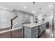 Modern kitchen island with stainless steel appliances and convenient access to the living area at 1448 Big Falls Dr, Wendell, NC 27591