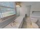 Comfortable bathroom, featuring vanity, a bright window for natural light, and a toilet at 1509 Logan St, Durham, NC 27704