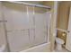 Bathroom featuring a bathtub with sliding glass doors and a toilet at 1509 Logan St, Durham, NC 27704