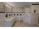 Clean bathroom with white tiled walls, large vanity, and a neutral color palette provides a relaxing space at 1509 Logan St, Durham, NC 27704