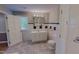 Bathroom featuring tiled floors and walls, a sink with storage, and updated fixtures at 1509 Logan St, Durham, NC 27704