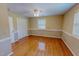 Bedroom featuring gleaming hardwood floors, a ceiling fan and a bright window at 1509 Logan St, Durham, NC 27704