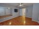 Spacious bedroom with wood floors, ceiling fan, and access to another room at 1509 Logan St, Durham, NC 27704