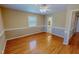 Spacious bedroom with hardwood floors, neutral walls, and a view into the bathroom at 1509 Logan St, Durham, NC 27704
