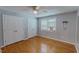 Bedroom with hardwood floors, ceiling fan, and ample closet space at 1509 Logan St, Durham, NC 27704