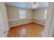 Bedroom with light hardwood floors, neutral walls, and two windows at 1509 Logan St, Durham, NC 27704