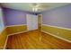 Bright bedroom featuring wood floors, ceiling fan and two-tone walls, creating a cozy atmosphere at 1509 Logan St, Durham, NC 27704