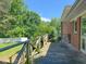 Exterior wooden deck with views of green lawn and beautiful, mature trees at 1509 Logan St, Durham, NC 27704