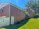 Brick two story home with a lawn and side access door at 1509 Logan St, Durham, NC 27704