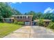 Traditional brick two-story house with a wide driveway and mature trees at 1509 Logan St, Durham, NC 27704