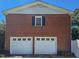 Exterior view of the two-car garage with brick facade and white garage doors at 1509 Logan St, Durham, NC 27704