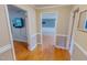 Hallway with wood floors and multiple doorways to different rooms at 1509 Logan St, Durham, NC 27704