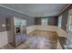 Well-lit kitchen/dining area featuring stainless steel refrigerator and tiled flooring at 1509 Logan St, Durham, NC 27704