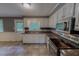 A bright kitchen with white cabinets, stainless steel appliances, and granite countertops at 1509 Logan St, Durham, NC 27704