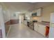 View of the kitchen featuring stainless steel appliances, tiled floor, and white cabinets at 1509 Logan St, Durham, NC 27704