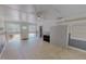 Bright living room with tiled floors, ceiling fan, and front door access, plus modern storage solutions at 1509 Logan St, Durham, NC 27704