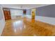 Bright living room with hardwood floors, a large window, and access to another room at 1509 Logan St, Durham, NC 27704