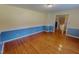 Living room featuring hardwood flooring, wainscoting, and a open floorplan at 1509 Logan St, Durham, NC 27704