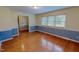 Living room with hardwood flooring, wainscoting, and several windows for ample natural light at 1509 Logan St, Durham, NC 27704
