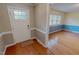 Bright living room featuring hardwood floors, wainscoting, and plenty of natural light at 1509 Logan St, Durham, NC 27704