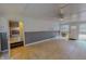 Large living space with tiled flooring, a ceiling fan, and access to an exterior door and hallway at 1509 Logan St, Durham, NC 27704