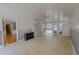 Open living space with tiled flooring, a ceiling fan, and access to an exterior door and staircase at 1509 Logan St, Durham, NC 27704