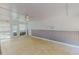 Bright sunroom with tile flooring, wainscoting, and natural light from the windows at 1509 Logan St, Durham, NC 27704