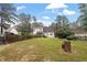 Spacious backyard featuring a two-story home with a fenced perimeter and mature trees at 151 Donnibrook, Fuquay Varina, NC 27526