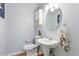 Charming half bath features a pedestal sink, tile floor, and a wall cabinet at 151 Donnibrook, Fuquay Varina, NC 27526