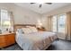 Comfortable primary bedroom is bathed in light from two large windows at 151 Donnibrook, Fuquay Varina, NC 27526