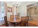 Elegant dining room with a chandelier, hardwood floors, and seating for six around a wooden table at 151 Donnibrook, Fuquay Varina, NC 27526