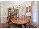 Charming dining room features a wooden table and chairs, complemented by a china cabinet and soft, natural lighting at 151 Donnibrook, Fuquay Varina, NC 27526