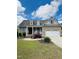 Charming brick home featuring a well-manicured lawn, dormers, and a two-car garage at 151 Donnibrook, Fuquay Varina, NC 27526