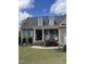 Charming brick home with a well-manicured lawn and a welcoming covered front porch at 151 Donnibrook, Fuquay Varina, NC 27526