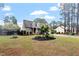 Well-maintained brick home with dormer windows, blue shutters, manicured landscaping, and a spacious front yard at 151 Donnibrook, Fuquay Varina, NC 27526