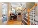 Bright foyer showcasing hardwood floors, a staircase, and a glimpse into the living room with a fireplace at 151 Donnibrook, Fuquay Varina, NC 27526