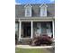 Inviting front porch with classic details, decorative planters, and comfortable seating at 151 Donnibrook, Fuquay Varina, NC 27526