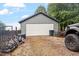 Spacious detached garage with a multi-panel door, side access, and ample outdoor storage space at 151 Donnibrook, Fuquay Varina, NC 27526