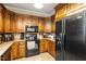 Traditional kitchen with stainless steel appliances and warm oak cabinetry at 151 Donnibrook, Fuquay Varina, NC 27526